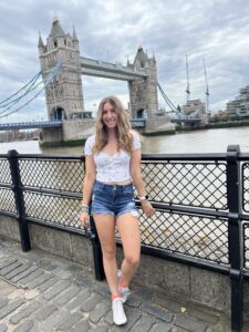 Photo of Samantha Marchica smiling in front of a bridge